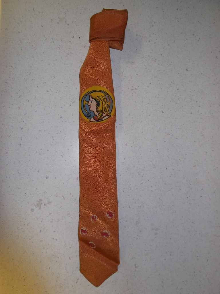 Gold and orange Necktie-TI 5009- Tie has sheen and picture of girl on it. Painted design on end.