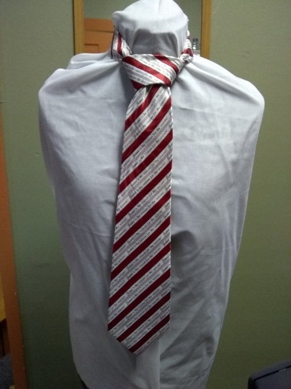 Red and white Necktie-TI 7274- Diagonal stripes with "Jesus is the Reason for the Season" across.