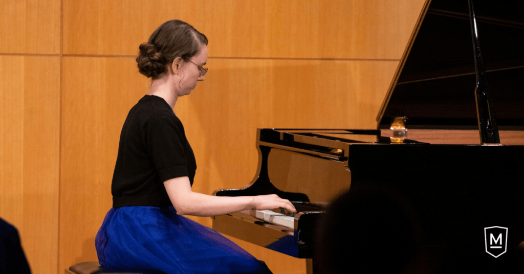 Makayla Stevenson playing piano during senior recital