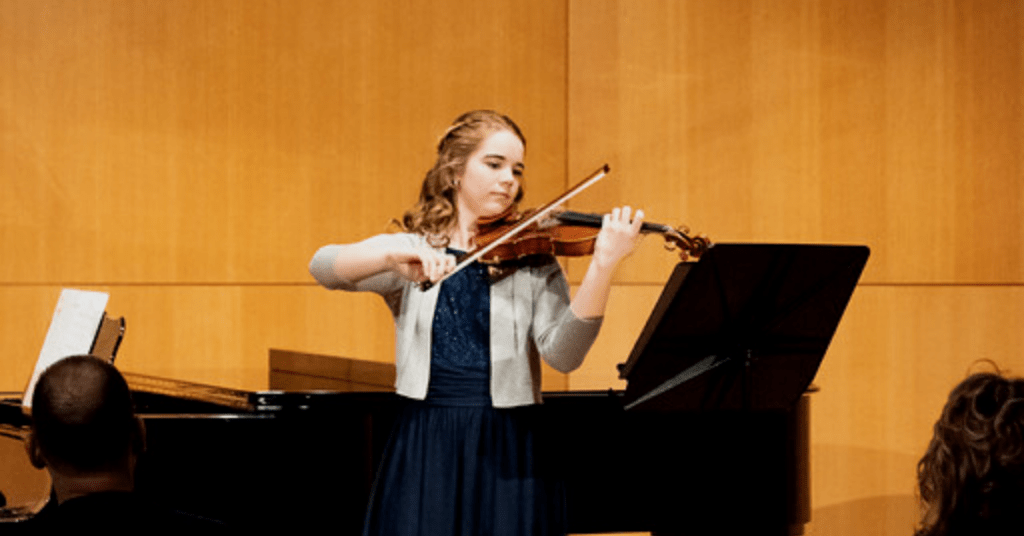 Sarah Bagin playing her violin in her minor violin recital.
