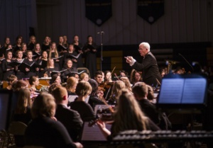 director leading orchestra and choir